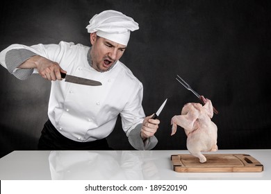 Angry cook fighting with knifes. Raw chicken attack