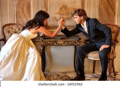 Angry couple battling it off with some arm wrestling