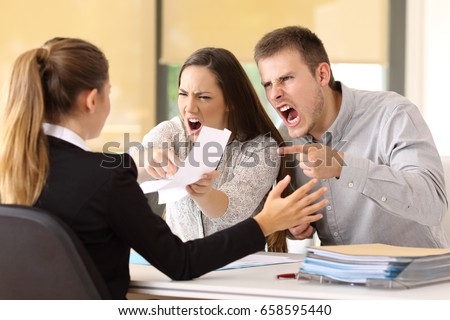 Angry couple claiming and shouting to an office worker 