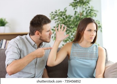 Angry Couple Fighting Sitting On A Couch At Home