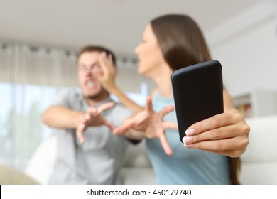 Angry couple or marriage fighting for a mobile phone at home