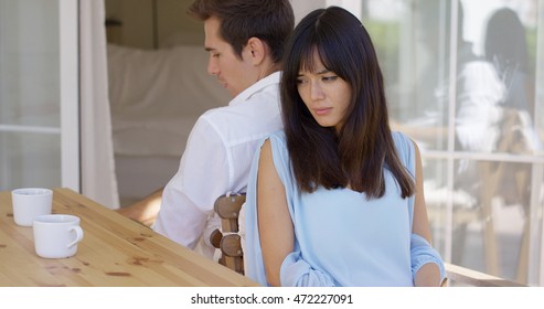 Angry couple sitting back to back at table - Shutterstock ID 472227091