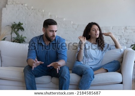 Angry couple talking in emotional conflict, arguing, shouting. Annoyed worried husband and wife disputing, discussing problems, divorce, abuse, break up, going through relationship crisis