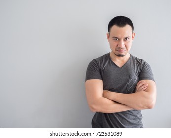 Angry and crazy asian man in black t-shirt and skinhead hair style.