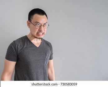 Angry And Crazy Asian Man In Black T-shirt And Skinhead Hair Style.