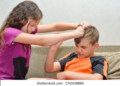 An angry and cruel older sister scolds her brother and grabs his hair, social problems of raising a family with children.