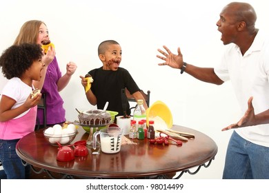 Angry Dad Finds Kids Making Mess With Cupcakes In The Kitchen.  Interacial Family Over White.