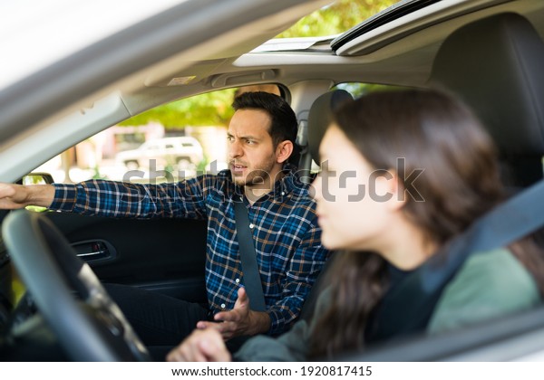 Angry dad\
screaming to her adolescent daughter during her driving lessons\
because she caused a car crash for speeding\
