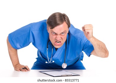 Angry Doctor In Blue Posing At Table