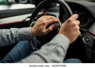 angry driver presses the horn of the car to attract the attention of the car bully and avoid road accident. Stress and aggressive driving on city streets