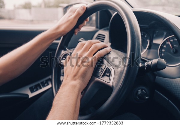 angry driver presses the horn of the car to\
attract the attention of the car bully and avoid road accident.\
Stress and aggressive driving on city\
streets