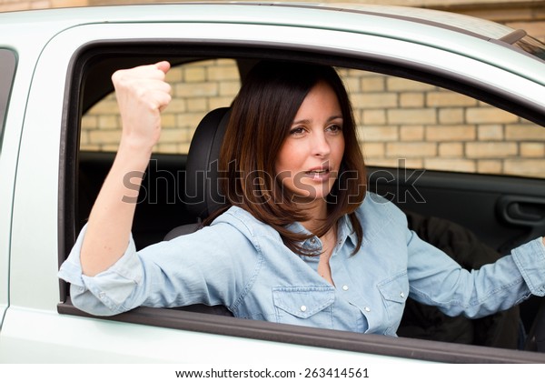 angry driver waving\
fist