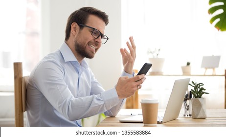 Angry Employee Annoyed By Broken Or Discharged Mobile Phone, Receiving Bad News, Furious Businessman Looking At Smartphone Screen, Missed Or Unwanted Call, Problem With Mobile Device App