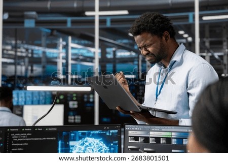 Angry engineer in data center annoyed by errors affecting equipment while using artificial intelligence computerized model. Irked server room employee frustrated by broken AI deep learning algorithms