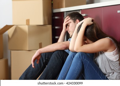 Angry Evicted Couple Worried Moving House Sitting On The Floor In The Kitchen