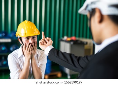 Angry Factory Manager Giving Middle Finger, Fuck You, Sign To His Stressed Female Worker For Mistake In Manufacturing Factory. Aggressive, Furious, Stressed, Hate, Argument From Industry Work.