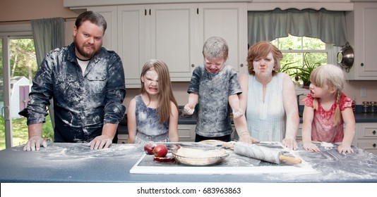 An Angry Family In The Kitchen After A Food Fight And Baking An Apple Pie.       