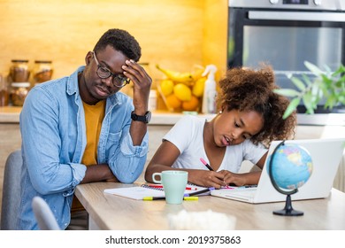 The Angry Father And A Daughter Doing Homework At The Desk. Father Argues With His Daughter About Book Facts. Dad Is Angry Because His Daughter Don't Want To Do Her Homework