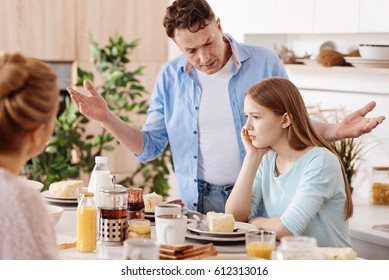 Angry father giving lesson to his daughter
