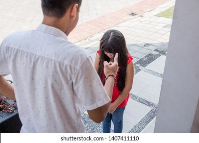 Angry Father Scolding Daughter In Front Of The House