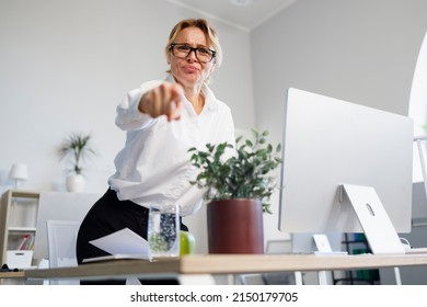 Angry Female Boss In Office Pointing Finger