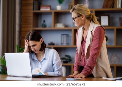 Angry female boss scolding scared office worker. Demanding manager leader is annoyed at laziness and mistakes in work of employee. Authoritarian leadership, abuse of power, malfeasance in office - Shutterstock ID 2176595271
