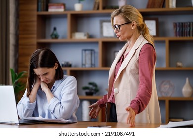 Angry Female Boss Scolding Scared Office Worker. Demanding Manager Leader Is Annoyed At Laziness And Mistakes In Work Of Employee. Authoritarian Leadership, Abuse Of Power, Malfeasance In Office