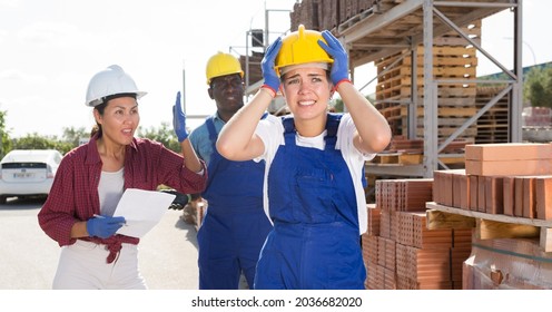 Angry Female Boss Scolds Her Young Girl Subordinate At A Building Materials Warehouse, Pointing Out Her Mistakes