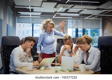 Angry Female Boss Yelling To Employees