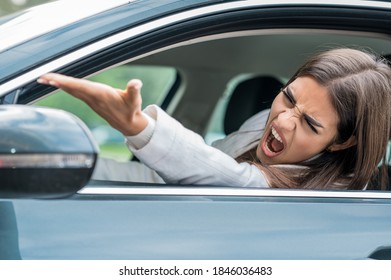 Angry female driving car in the traffic jam