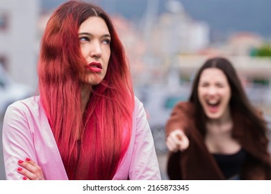 Angry Female Friends Arguing In The Street