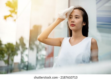 Angry Female Having Sunstroke Skin Damage From Sun UV City Air Pollution Outside On Street, Overheating Asian Beautiful Business Woman Drying Sweat Her Face With Cloth In Warm Summer Day Hot Weather