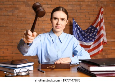 Angry Female Judge At Table In Courtroom