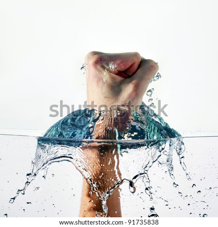 An angry fist punching water isolated on white background