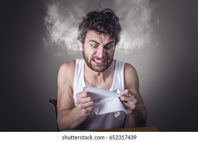 Angry Frustrated Man Tearing Apart Is Bills, Smoke Coming Out Of His Head