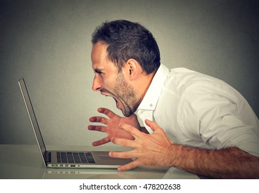 Angry Furious Business Man Screaming At Computer. Negative Human Emotions, Facial Expressions, Feelings, Aggression, Anger Management Issues Concept