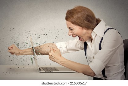 Angry Furious Businesswoman Throws A Punch Into Computer, Screaming. Negative Human Emotions, Facial Expressions, Feelings, Aggression, Anger Management Issues Concept