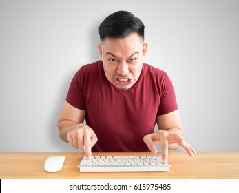 Angry And Furious Face Of Asian Man Working With Computer In The Office.