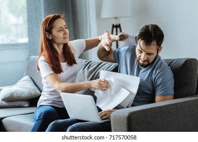Angry furious woman attacking her boyfriend - Shutterstock ID 717570058