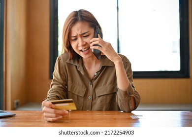 Angry And Furious Young Asian Woman Calling Credit Card Call-centre Service To Complain About Her Problems. Online Payment, Internet Banking Concept