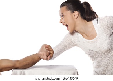 angry girl wrestles hand with men