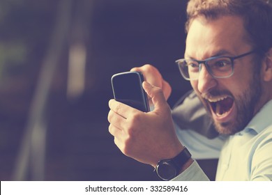 Angry Guy Biting The Phone.