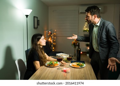 Angry Hispanic Couple With A Lot Of Relationship Problems Having A Fight During A Fancy Dinner Date At Home