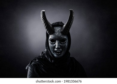 Angry horned demon in the dark