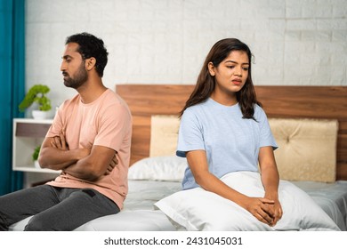 Angry Indian couple arguing each other at bedroom while sleeping - concept of family problems, relationship conflict and misunderstanding. - Powered by Shutterstock