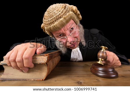 Angry judge in extreme wide angle closeup with hammer and wig