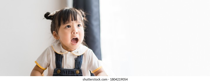 Angry Kid.Little Asian Girl Looking At Her Mother And Fighting With Her Mom.Furious Hungry Toddler Kid Got Upset And Sad And She Has A Negative Attitude.Depressed Little Girl Complaining.Ef In Kid.