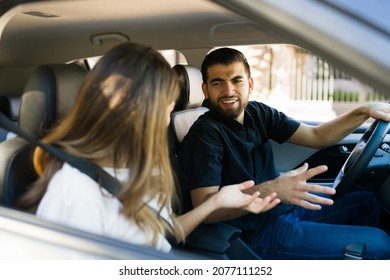 Angry Latin Man Fighting With Her Girlfriend While Driving The Car. Upset Couple Arguing During A Road Trip 