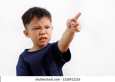 Angry Little Asian Boy Showing Frustration With Hand And Finger Pointing To Side, Isolated On White Background.