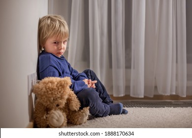 Angry Little Toddler Child, Blond Boy, Sitting In Corner With Teddy Bear, Punished For Mischief
